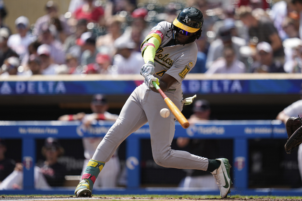 Athletics' Lawrence Butler (4) hits a three-run double during the second inning of a baseball game against the Minnesota Twins, Thursday, Aug. 21, 2025, in Minneapolis. (AP Photo/Abbie Parr)