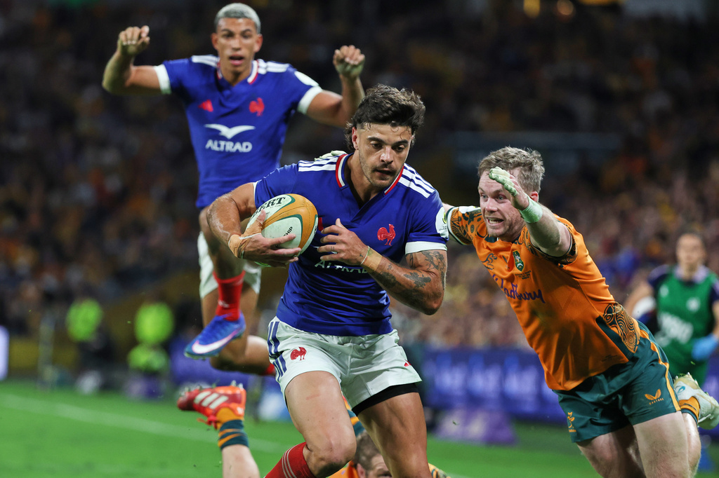 France's Romain Ntameck breaks the tackle of Australia's Ryan Lonergan, right, to score a try during the Nations Championship rugby international between France and Australia in Brisbane, Australia, Saturday, July 11, 2026. (AP Photo/Tertius Pickard)