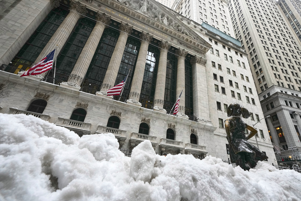 The Fearless Girl statue stands in the snow in front of the New York Stock Exchange, Monday, Jan. 26, 2026. (AP Photo/Richard Drew)