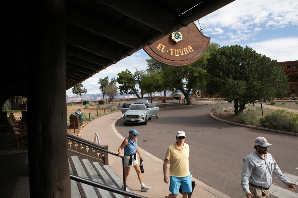 Tourists check out of the El Tovar Hotel as lodging along the rim of the canyon was shut down due to flooding, Monday, Aug. 31, 2026 at Grand Canyon National Park, Ariz. (AP Photo/Josh Biggs)
