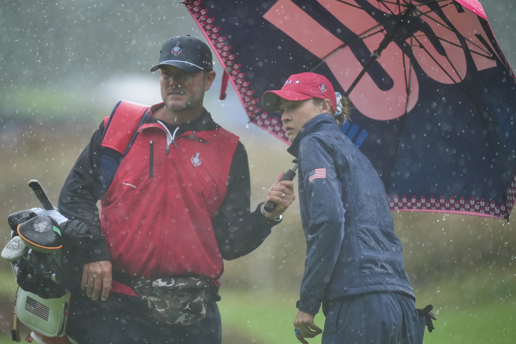 Nelly Korda of the United States reacts after putting on the 13th green in heavy rain during a practice round for the Solheim Cup at the Bernardus Golf course in Vught, Netherlands, Wednesday, Sept. 9, 2026. (AP Photo/Alastair Grant)