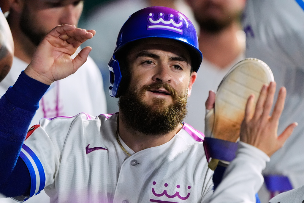 Kansas City Royals' Kyle Isbel celebrates in the dugout after scoring on a single by Maikel Garcia during the eighth inning of a baseball game against the Detroit Tigers, Friday, May 8, 2026, in Kansas City, Mo. (AP Photo/Charlie Riedel)