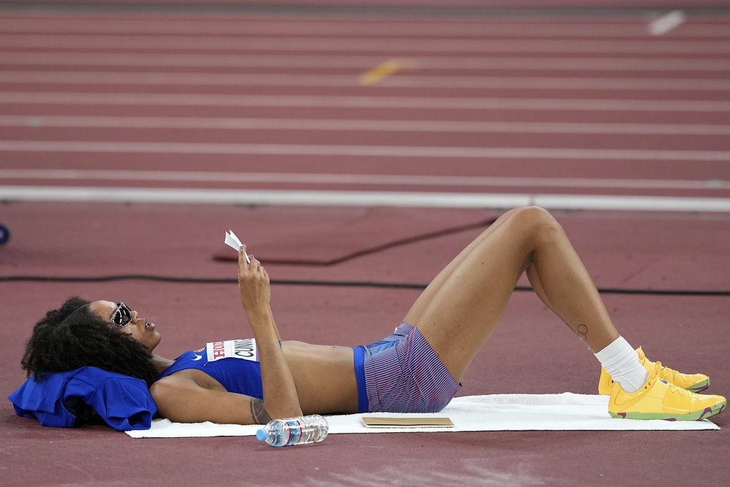 United States' Vashti Cunningham reads her notes while waiting her turn in the women's high jump qualification at the World Athletics Championships in Tokyo, Thursday, Sept. 18, 2025. (AP Photo/Matthias Schrader)