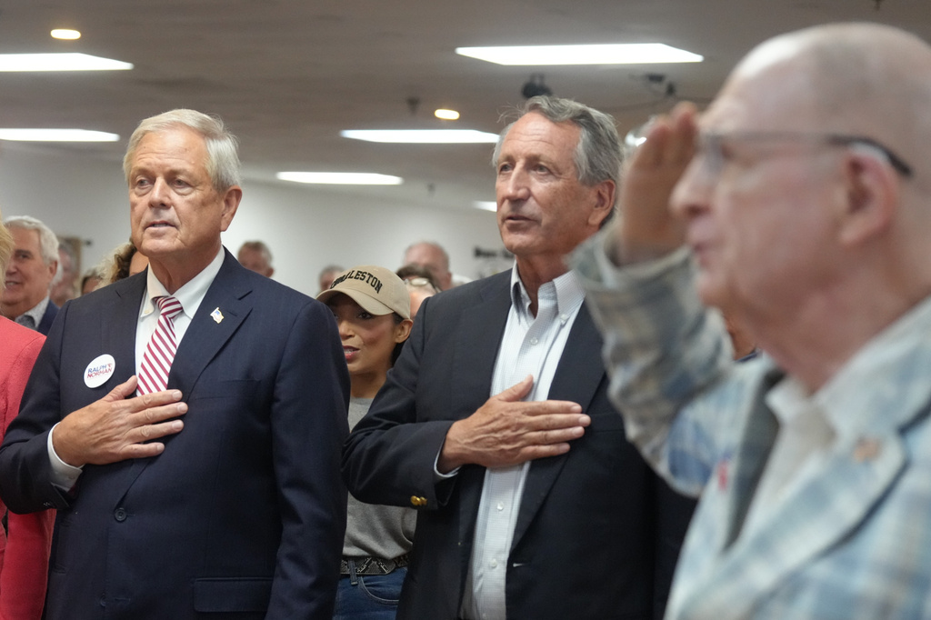 U.S. Rep. Ralph Norman, R-S.C., left, and former Gov. Mark Sanford say the Pledge of Allegiance ahead of a candidate event days before the special South Carolina Republican primary to replace Sen. Lindsey Graham, R-S.C., Thursday, Aug. 6, 2026, in Charleston, S.C. (AP Photo/Meg Kinnard)