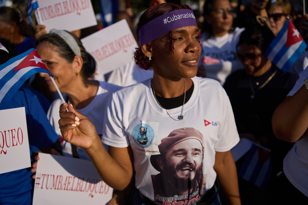 A woman attends a rally calling for the end of the U.S. blockade against the island nation in Havana, Cuba, Tuesday, April 7, 2026. (AP Photo/Ramon Espinosa)