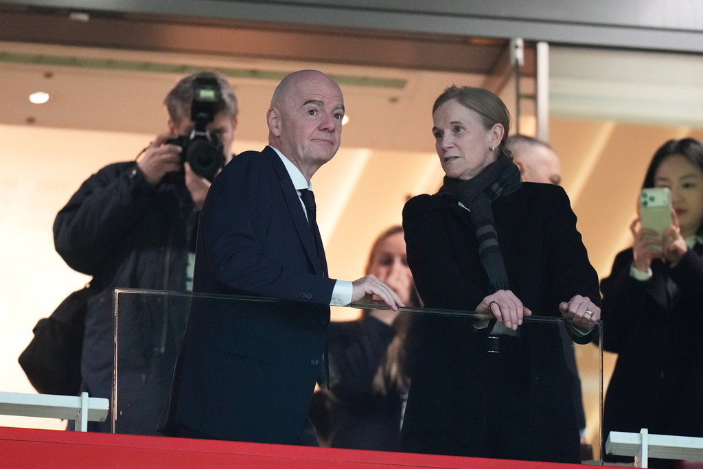 FIFA President Gianni Infantino and Chief Football Officer Jill Ellis chat on the tribune before the start of the Women's Champions Cup final soccer match between Arsenal FC and SC Corinthians in London, Sunday, Feb. 1, 2026. (AP Photo/Alastair Grant)