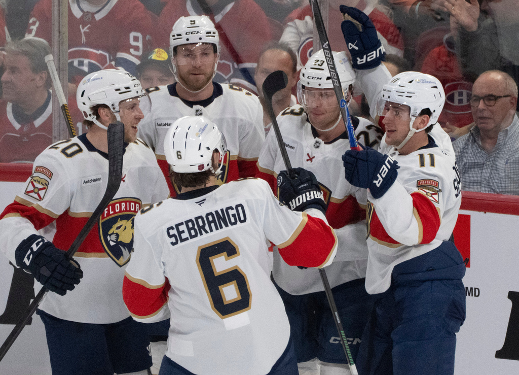 Florida Panthers' Carter Verhaeghe (23) celebrates his goal over the Montreal Canadiens with teammates during first period NHL hockey action in Montreal on Tuesday, April 7, 2026. (Christinne Muschi/The Canadian Press via AP)