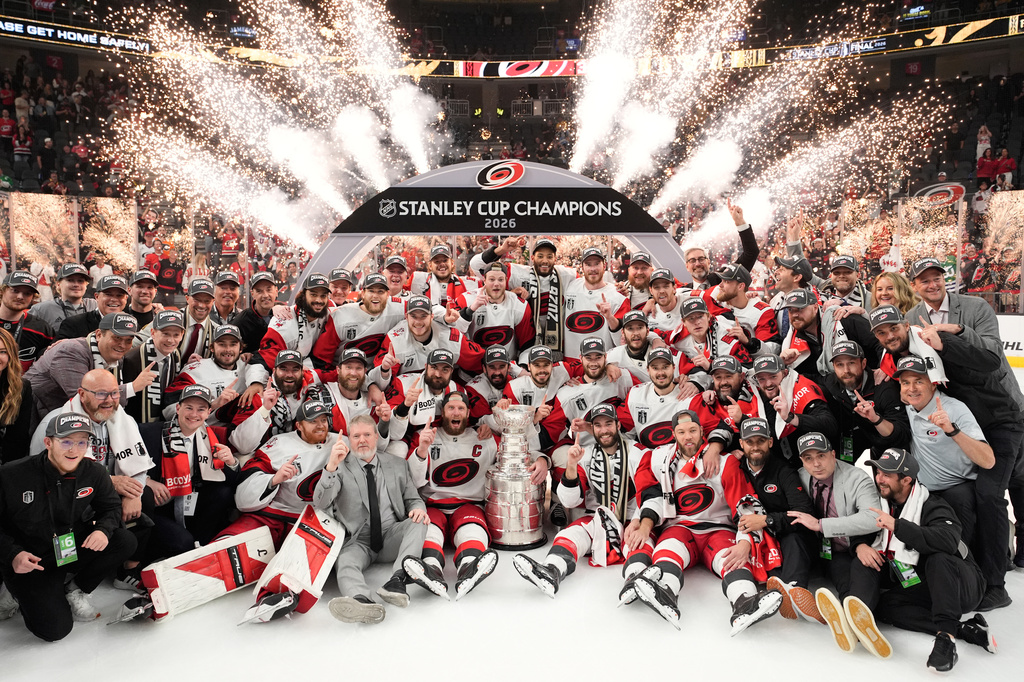 The Carolina Hurricanes pose for photos after a win over the Vegas Golden Knights in Game 6 of the NHL hockey Stanley Cup Final series, Sunday, June 14, 2026, in Las Vegas. (AP Photo/John Locher)