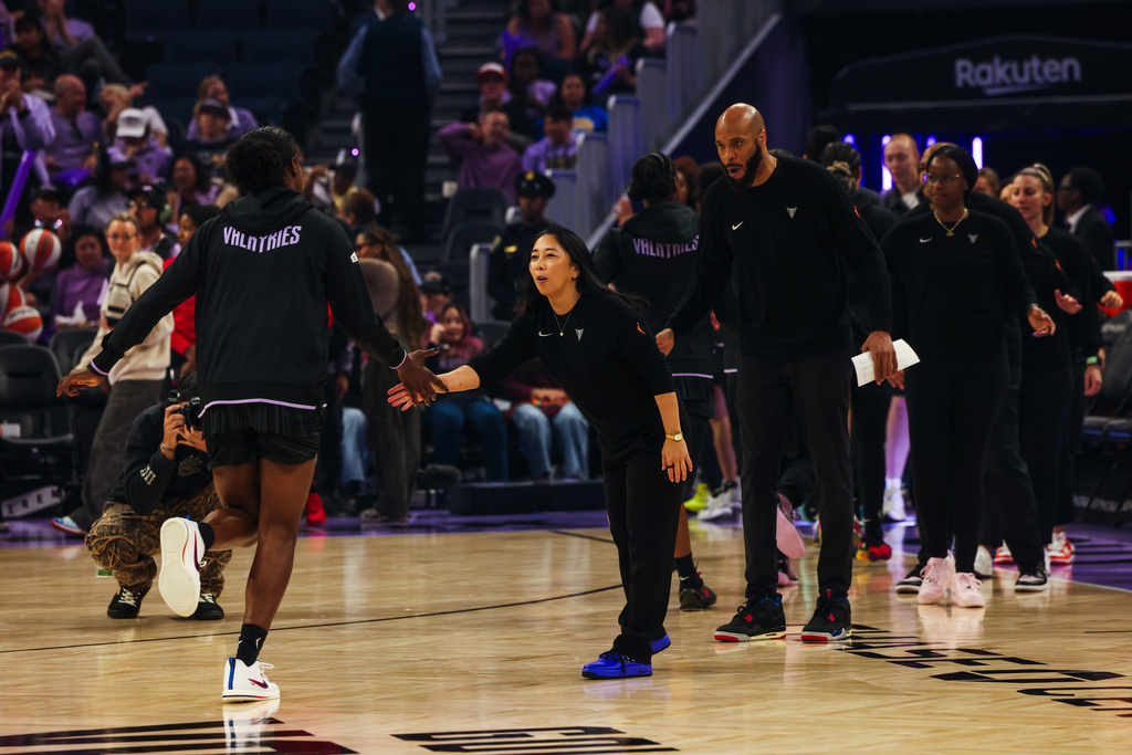 The Golden State Valkyries head coach Natalie Nakase low fives her players as they exit the court before competing against the Washington Mystics during a WNBA basketball game in San Francisco on Saturday, July 18, 2026. (Yalonda M. James/San Francisco Chronicle via AP)