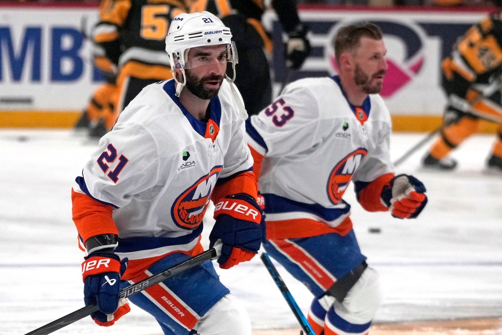 New York Islanders' Casey Cizikas (53), and Kyle Palmieri (21) skate during warm ups before an NHL hockey game against the Pittsburgh Penguins in Pittsburgh, Thursday, Oct. 9, 2025. (AP Photo/Gene J. Puskar)