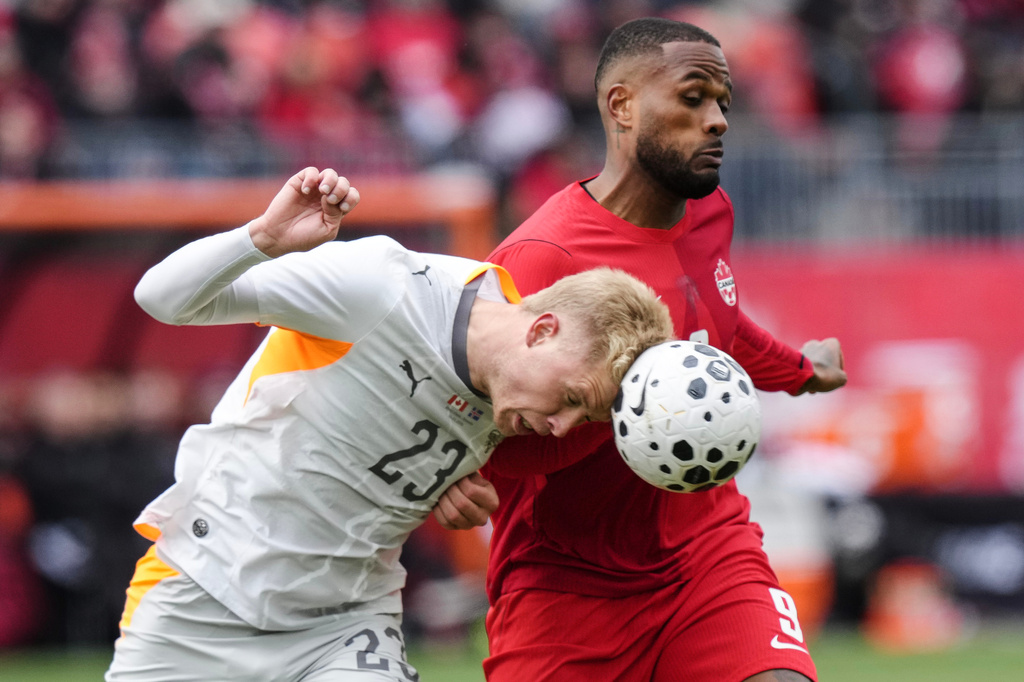 Iceland's Hordor Bjorgvin Magnusson, left, heads the ball away from Canada's Cyle Larin during an international friendly soccer match in Toronto, Saturday March 28, 2026. (Chris Young/The Canadian Press via AP)