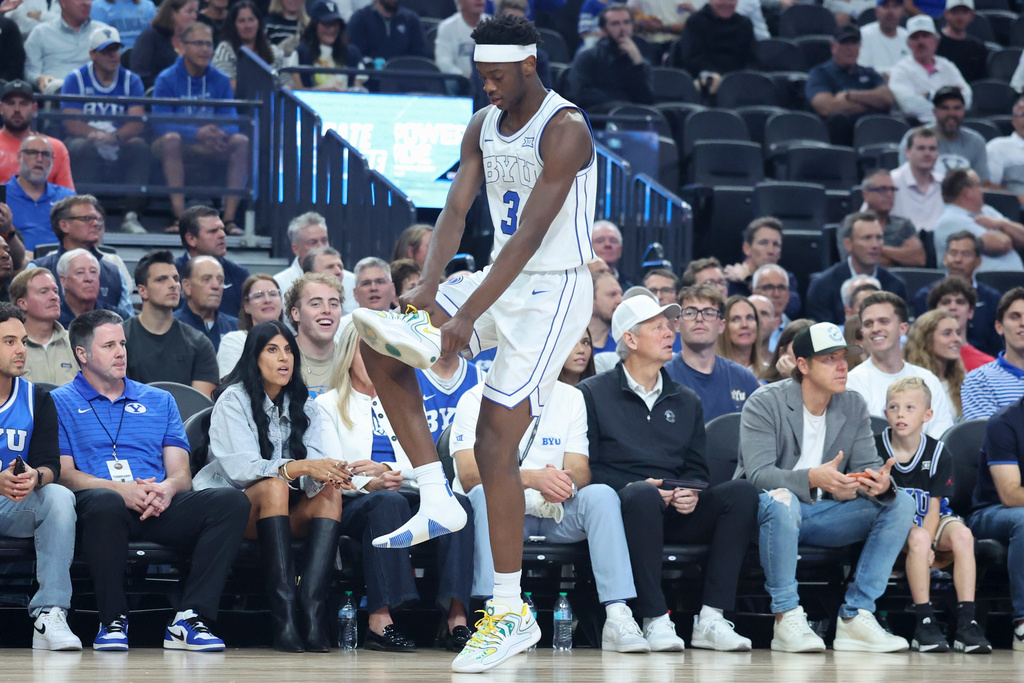 BYU forward AJ Dybantsa (3) puts on his shoe during the first half of an NCAA college basketball game against Villanova, Monday, Nov. 3, 2025, in Las Vegas. (AP Photo/Ian Maule)