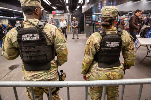 FILE - Members of the Armed Forces, including the National Guard, patrol the subway system in Penn Station as police officers check commuters' bags in New York on Thursday, March 7, 2024. (AP Photo/Ted Shaffrey, File) FILE - Members of the Armed Forces, including the National Guard, patrol the subway system in Penn Station as police officers check commuters' bags in New York on Thursday, March 7, 2024. (AP Photo/Ted Shaffrey, File)
