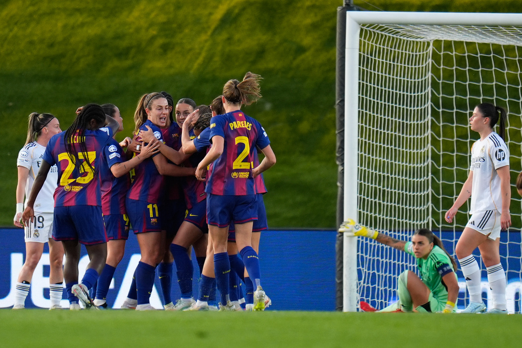 Barcelona players celebrate after Esmee Brugts scored her side's second goal during the women's Champions League quarterfinal first leg soccer match between Real Madrid and Barcelona in Madrid, Spain, Wednesday, March 25, 2026. (AP Photo/Manu Fernandez)