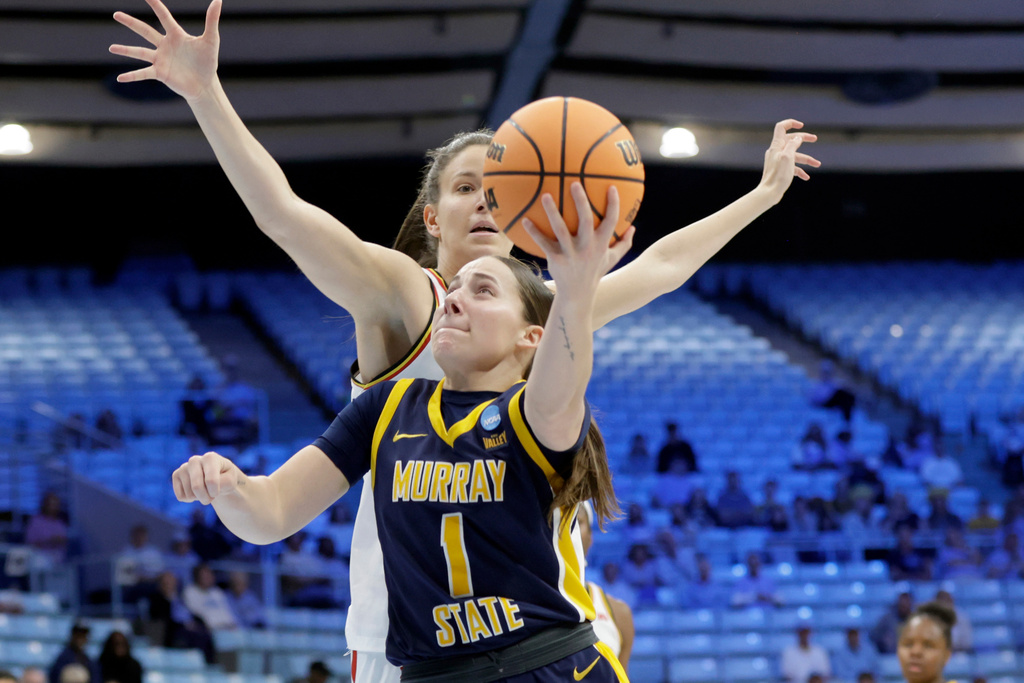 Murray State guard Halli Poock (1) drives past Maryland guard Yarden Garzon, back, during the first half in the first round of the NCAA college basketball tournament, Friday, March 20, 2026, in Chapel Hill, N.C. (AP Photo/Chris Seward)