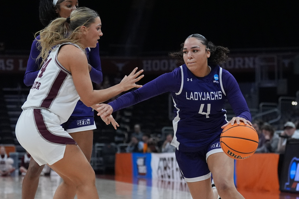 Stephen F. Austin guard Ashlyn Traylor-Walker (4) drives around Missouri State guard Kaemyn Bekemeier (24) during the second half in a First Four college basketball game in the NCAA Tournament, Wednesday, March 18, 20206, in Austin, Texas. (AP Photo/Eric Gay)