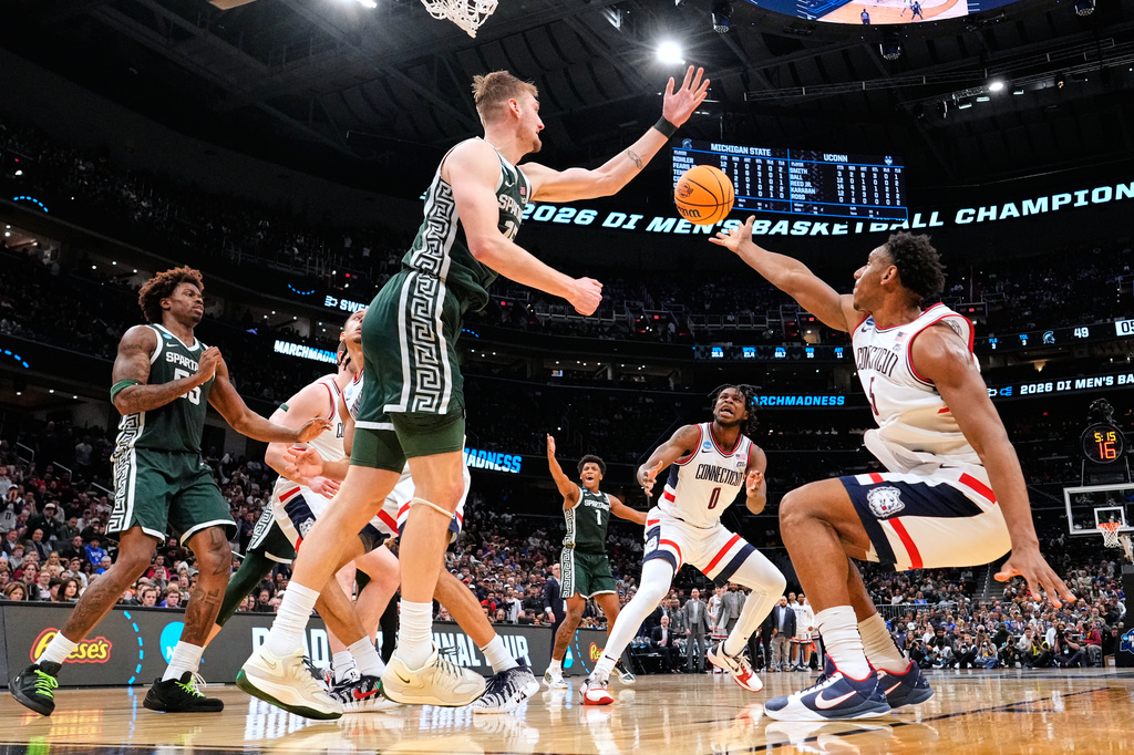 Michigan State center Carson Cooper (15) and UConn forward Tarris Reed Jr. (5) vie for the ball during the second half in the Sweet 16 of the NCAA college basketball tournament, Friday, March 27, 2026, in Washington. (AP Photo/Abbie Parr)