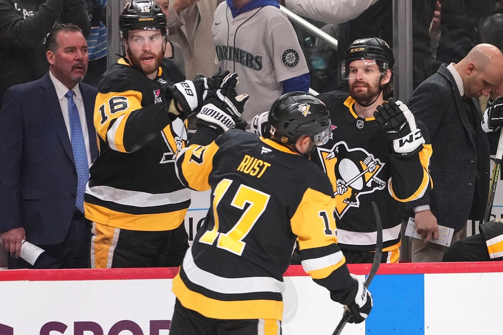 Pittsburgh Penguins' Bryan Rust (17) returns to the bench after scoring during the second period of an NHL hockey game against the Vegas Golden Knights in Pittsburgh, Sunday, March 1, 2026. (AP Photo/Gene J. Puskar)