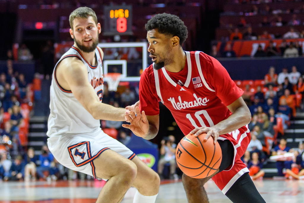 Nebraska's Jamarques Lawrence drives to the basket as Illinois' Tomislav Ivisic defends during an NCAA college basketball game Saturday, Dec. 13, 2025, in Champaign, Ill. (AP Photo/Craig Pessman)