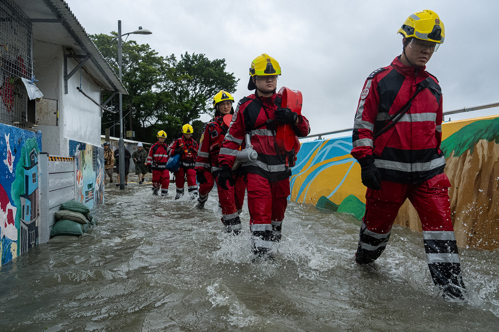 Firefighters walk through the floodwaters in Lei Yue Mun area as super typhoon Ragasa approaches in Hong Kong, Wednesday, Sept. 24, 2025. (AP Photo/Chan Long Hei)