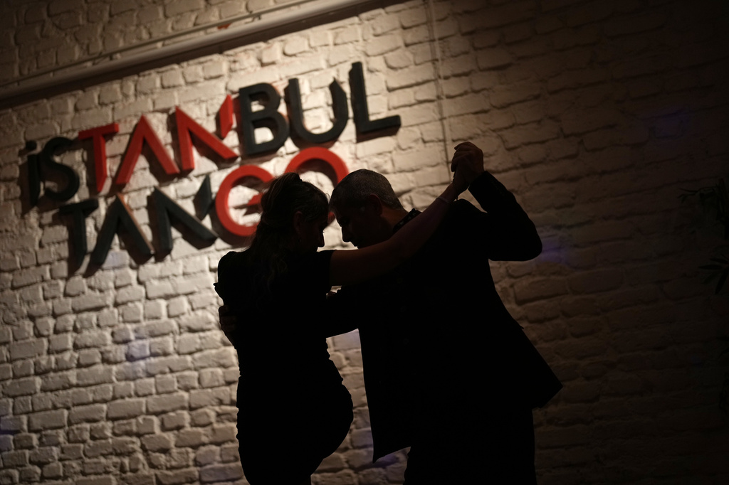 A couple dances tango during a milonga session at 333, a tango studio in Istanbul, Turkey, early Saturday, Jan. 10, 2026. (AP Photo/Francisco Seco)