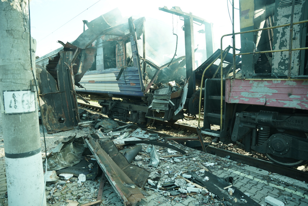 A passenger train is seen damaged following Russia's drone attack on a railway station in Shostka, Sumy region, Ukraine, Saturday, Oct. 4, 2025. (AP Photo/Kordon Media)