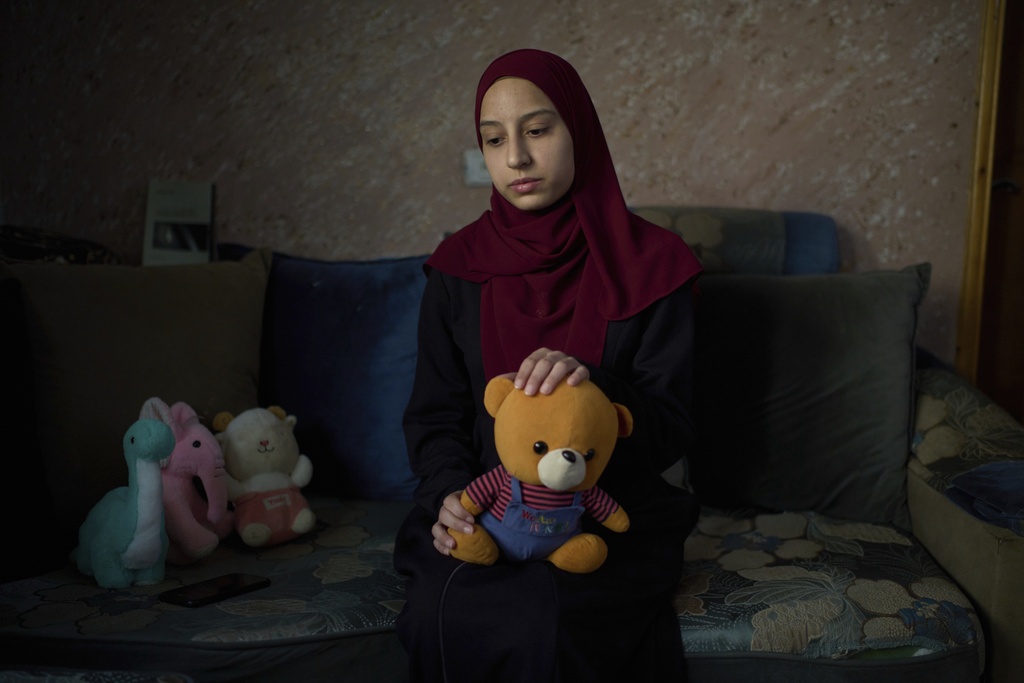 Tayma Asous, 26, holds the favorite toy of her 2-year-old daughter, Layla Al-Khatib, who was killed after being shot in the head by Israeli gunfire, at their home in the village of Muthallath ash-Shuhada, near the West Bank city of Jenin, March 11, 2025. (AP Photo/Leo Correa)