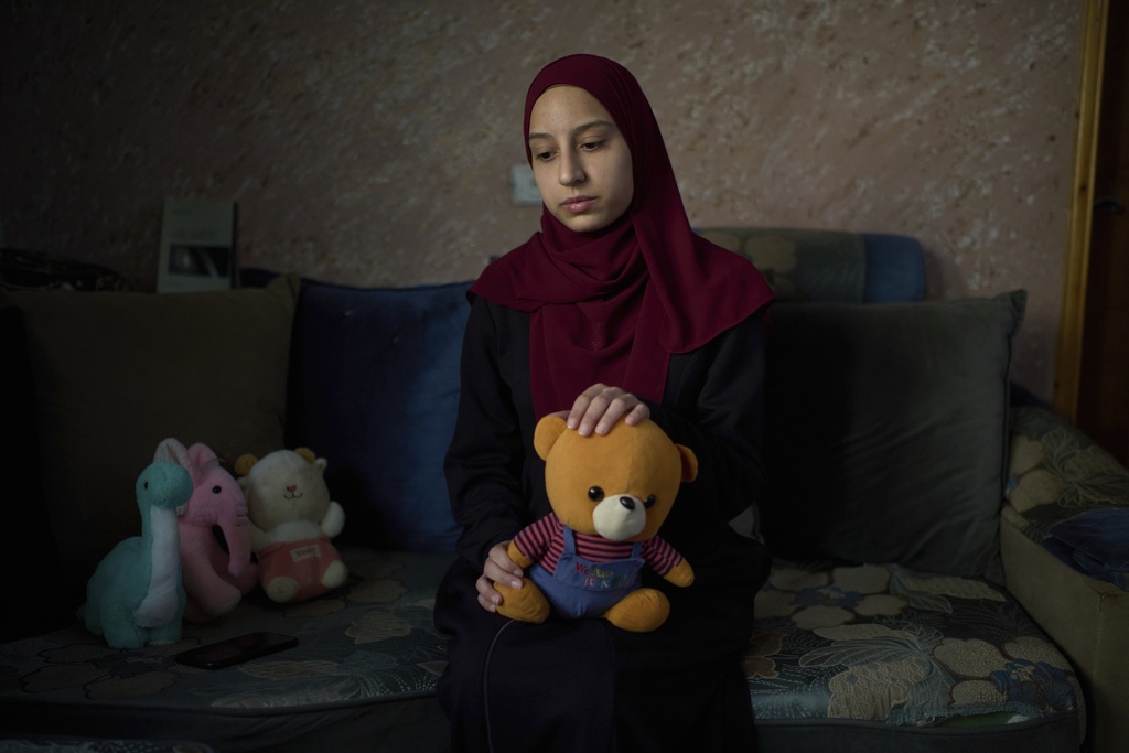 Tayma Asous, 26, holds the favorite toy of her 2-year-old daughter, Layla Al-Khatib, who was killed after being shot in the head by Israeli gunfire, at their home in the village of Muthallath ash-Shuhada, near the West Bank city of Jenin, March 11, 2025. (AP Photo/Leo Correa)