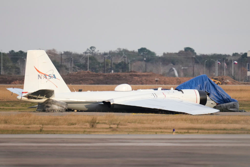 A NASA aircraft sits near a runway at Ellington Airport after making a belly landing on Tuesday, Jan. 27, 2026, in Houston. (AP Photo/Ashley Landis)