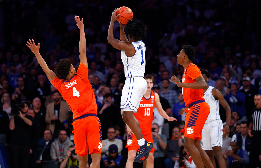 BYU guard Robert Wright III (1) makes the game winning shot against Clemson guard Efrem Johnson (4) during the second half of an NCAA basketball game, Tuesday, Dec. 9, 2025, in New York. (AP Photo/Noah K. Murray)