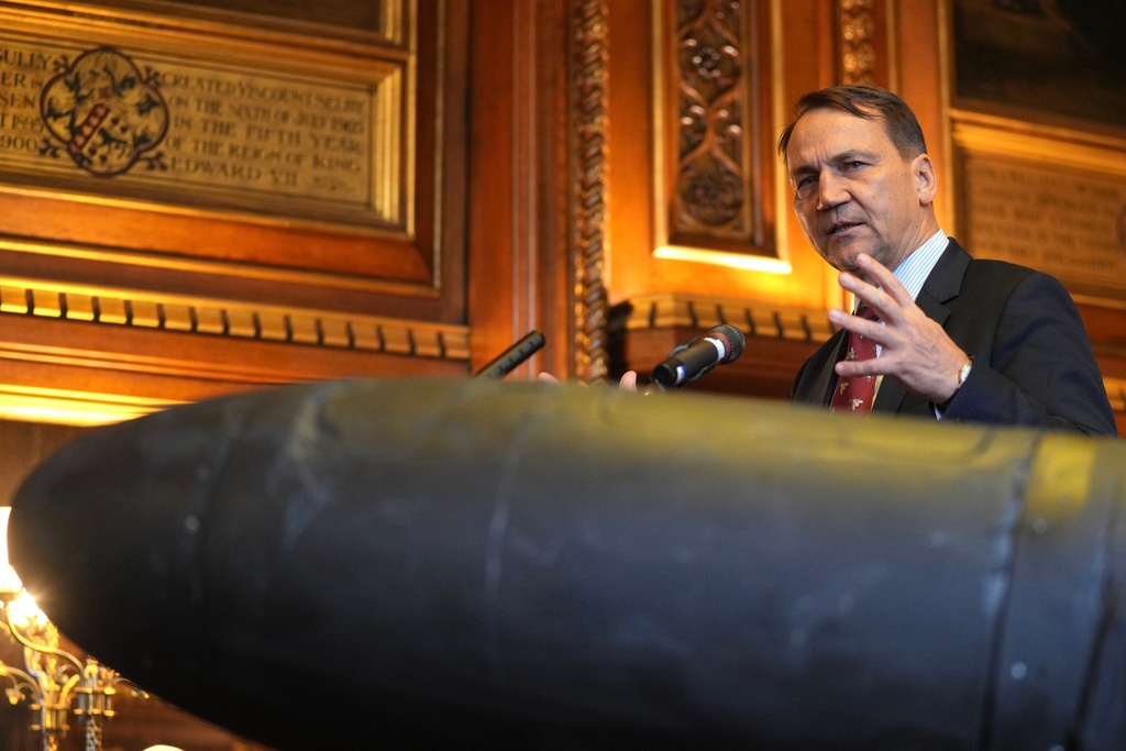 Poland's Foreign Minister Radek Sikorski speaks next to an Russian army's Iranian made Shahed-136 attack drone, acquired from Ukraine by United Against Nuclear Iran (UANI), at a press conference in Parliament in London, Tuesday, Oct. 14, 2025. (AP Photo/Kin Cheung)