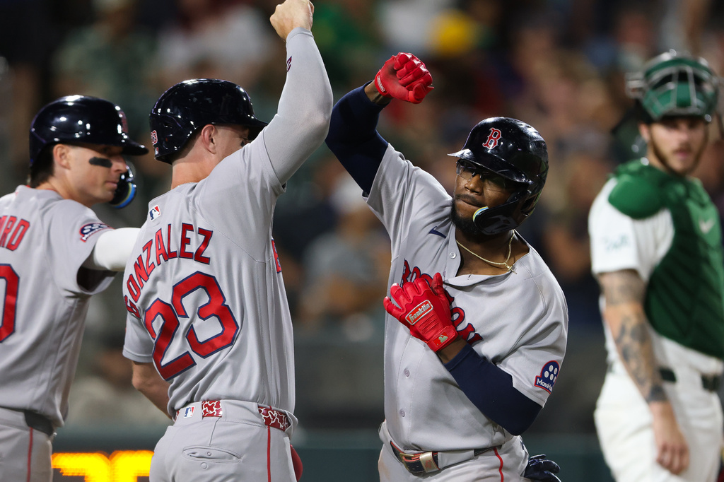 Boston Red Sox's Andruw Monasterio, right, celebrates with teammate Romy Gonzalez (23) after hitting a two-run home run during the 10th inning of a baseball game against the Athletics Wednesday, July 29, 2026, in West Sacramento, Calif. (AP Photo/Scott Marshall)
