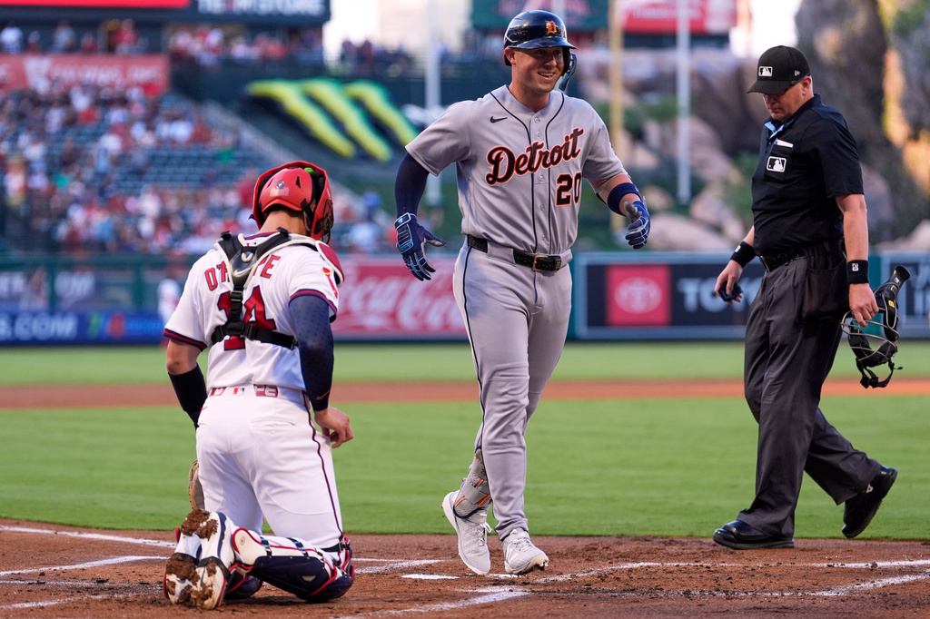Detroit Tigers' Spencer Torkelson, center, scores after hitting a three-run home run as Los Angeles Angels catcher Logan O'Hoppe, left, and home plate umpire Ryan Wills watch during the first inning of a baseball game Saturday, July 18, 2026, in Anaheim, Calif. (AP Photo/Mark J. Terrill)