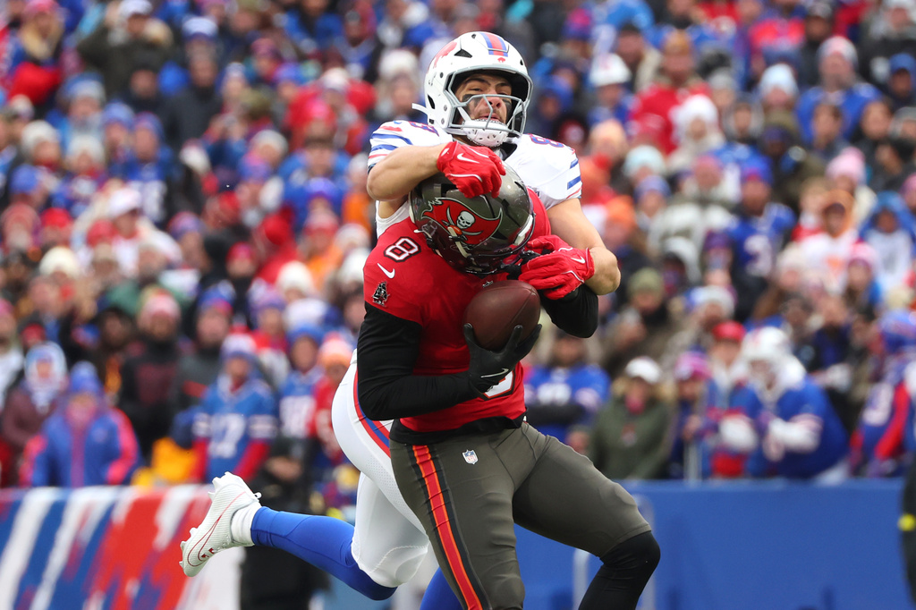 Tampa Bay Buccaneers linebacker SirVocea Dennis (8) intercepts the ball against Buffalo Bills tight end Dawson Knox, top, during the first half of an NFL football game, Sunday, Nov. 16, 2025, in Orchard Park, N.Y. (AP Photo/Jeffrey T. Barnes)