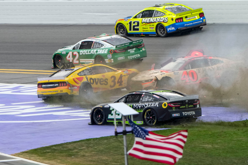 Riley Herbst, (35), Justin Allgaier, (40), Todd Gilliland, (34), John Hunter Nemechek, (42) and Ryan Blaney, (12) collide during the NASCAR Daytona 500 auto race at Daytona International Speedway, Sunday, Feb. 15, 2026, in Daytona Beach, Fla. (AP Photo/John Raoux)
