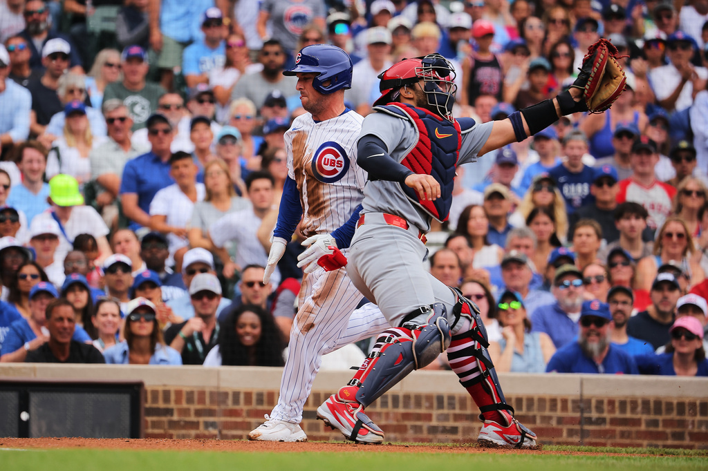 Chicago Cubs' Alex Bregman, center left, scores on an RBI single hit by teammate Nico Hoerner during the first inning of a baseball game against the St. Louis Cardinals, Sunday, July 5, 2026, in Chicago. (AP Photo/Melissa Tamez)