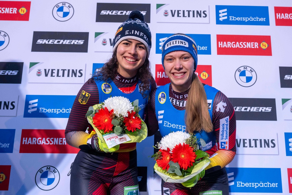 Germany's Jessica Degenhardt, left, and Cheyenne Rosenthal celebrate their victory after the women's doubles in the Luge World Championships in Winterberg, Germany, Saturday, Dec. 6, 2025. (David Inderlied/dpa via AP)