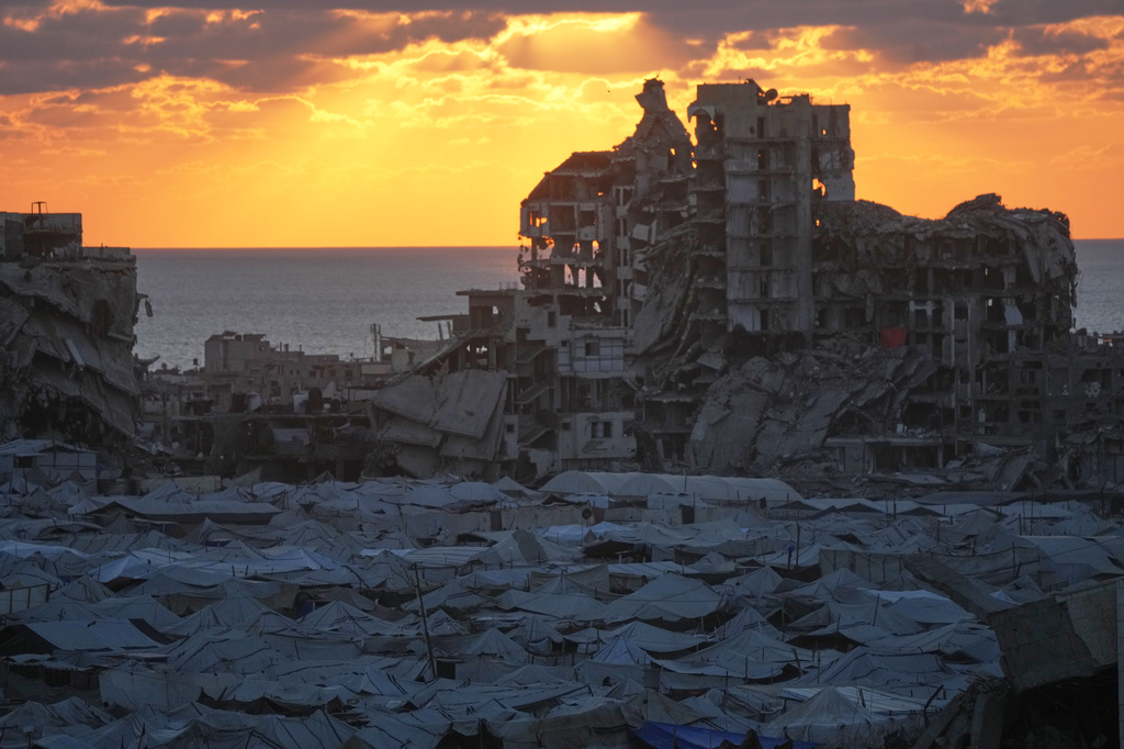 Tents sheltering displaced Palestinians are seen amid war-damaged buildings in Gaza City, Wednesday, Sept. 23, 2026. (AP Photo/Jehad Alshrafi)