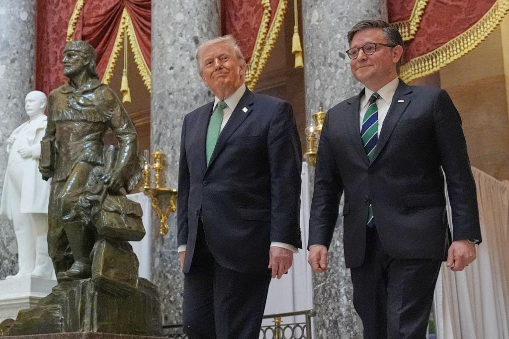 President Donald Trump walks through Statuary Hall with House Speaker Mike Johnson of La., as he departs Capitol Hill, Tuesday, March 17, 2026, in Washington. (AP Photo/Jacquelyn Martin)