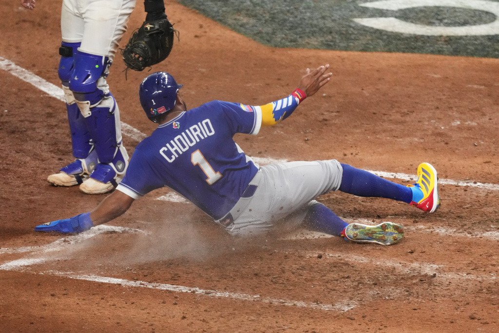 Venezuela Jackson Chourio (1) scores during the seventh inning of a World Baseball Classic semifinal game against Italy, Monday, March 16, 2026, in Miami. (AP Photo/Lynne Sladky)