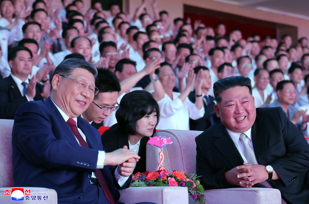 In this photo provided by the North Korean government, North Korean leader Kim Jong Un, right, and Chinese President Xi Jinping, left, smile as they watch welcome performance at Pyongyang Gymnasium in Pyongyang, Monday, June 8, 2026. Independent journalists were not given access to cover the event depicted in this image distributed by the North Korean government. The content of this image is as provided and cannot be independently verified. Korean language watermark on image as provided by source reads: "KCNA" which is the abbreviation for Korean Central News Agency. (Korean Central News Agency/Korea News Service via AP)