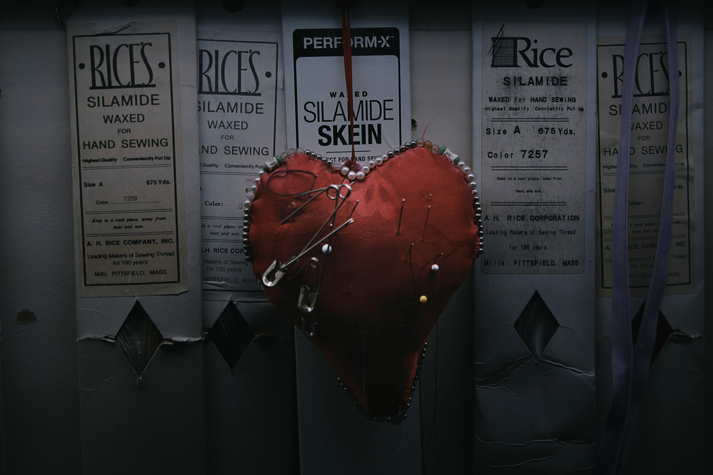 A heart-shaped pincushion bristling with needles hangs on the wall inside Kil Bae's store on Friday, March 27, 2026, in New York. (AP Photo/Andres Kudacki)