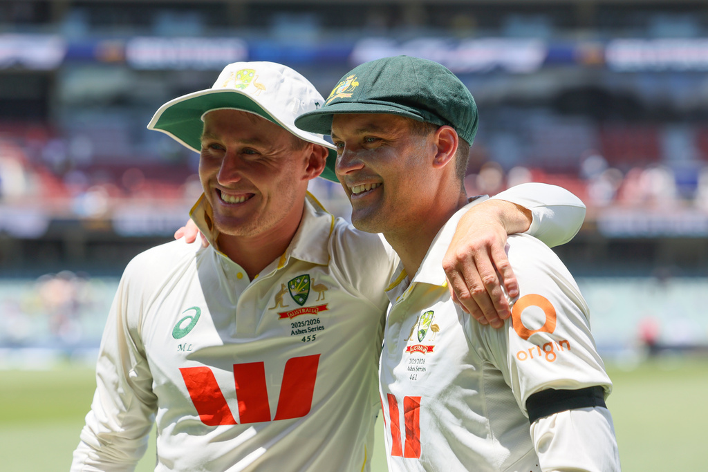 Australia's Alex Carey, right, and Australia's Marnus Labuschagne pose for a photo after Australia won the third Ashes Test against England in Adelaide, Australia, Sunday, Dec. 21, 2025. (AP Photo/James Elsby)