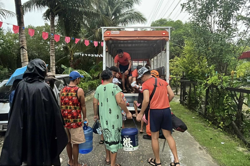 In this photo, provided by the Philippine Coast Guard, residents are evacuated to safer grounds as Typhoon Kalmaegi nears the area of Guiuan, Eastern Samar province, central Philippines on Monday Nov. 3, 2025. (Philippine Coast Guard via AP)