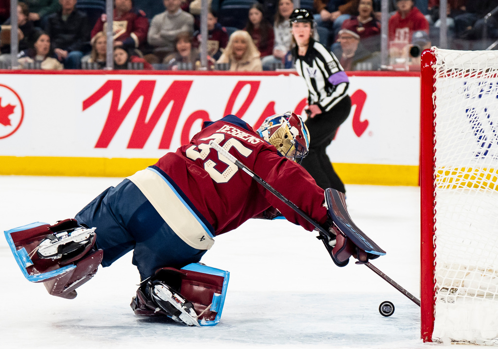 Montréal Victoire goaltender Ann-Renee Desbiens (35) reaches back to make a save against the Minnesota Frost during the first period of a PWHL hockey playoff game in Laval, Quebec, on Tuesday, May 12, 2026. (Christopher Katsarov/The Canadian Press via AP)