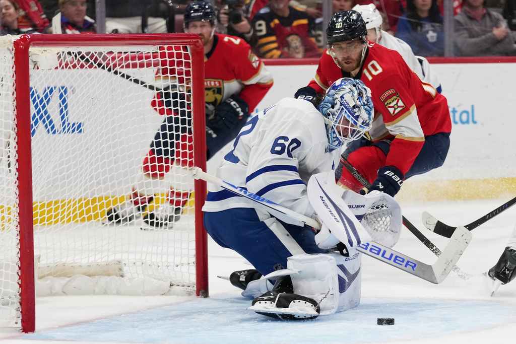 Toronto Maple Leafs goaltender Joseph Woll (60) defends a shot by Florida Panthers left wing A.J. Greer (10) during the second period of an NHL hockey game, Thursday, Feb. 26, 2026, in Sunrise, Fla. (AP Photo/Lynne Sladky)