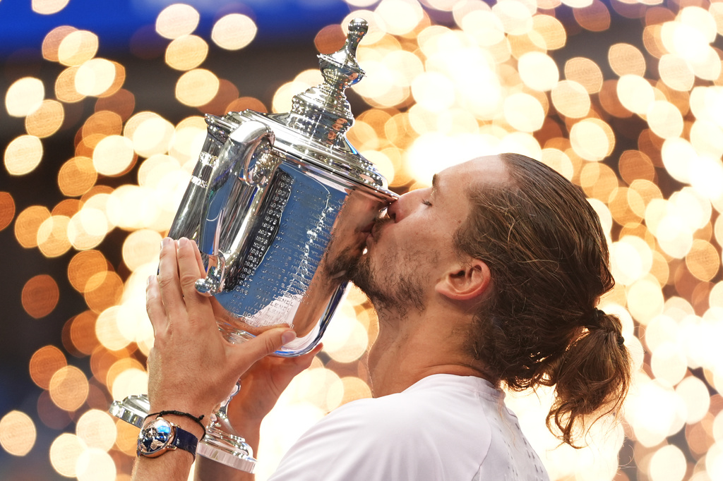 Alexander Zverev, of Germany, kisses the trophy after winning the men's singles final of the U.S. Open tennis championships against Ben Shelton, of the United States, Sunday, Sept. 13, 2026, in New York. (AP Photo/Frank Franklin II)