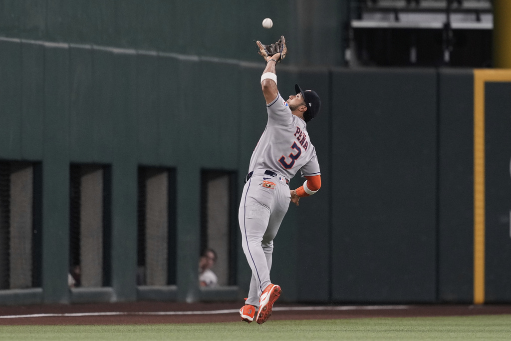Houston Astros shortstop Jeremy Pena races out to shallow left to catch a fly out by Texas Rangers' Michael Helman in the first inning of a baseball game Friday, Sept. 5, 2025, in Arlington, Texas. (AP Photo/Tony Gutierrez)