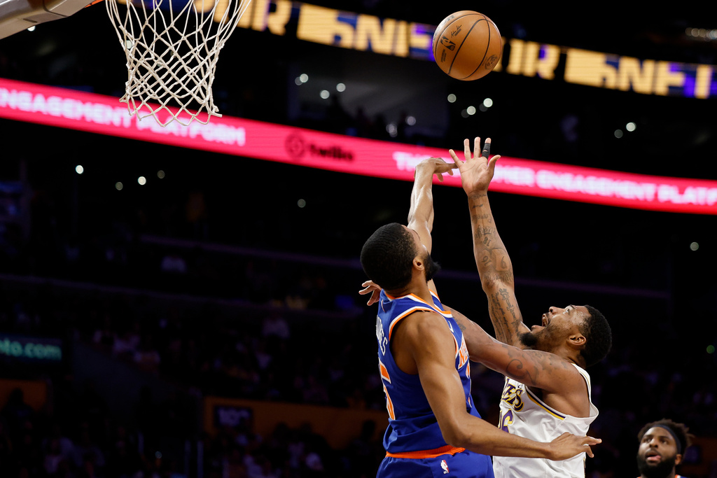 Los Angeles Lakers guard Marcus Smart, right, drives to the basket with the ball while being guarded by New York Knicks guard Mikal Bridgesduring the first half of an NBA basketball game Sunday, March 8, 2026, in Los Angeles. (AP Photo/Caroline Brehman)