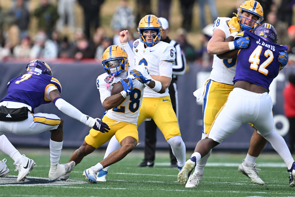 Pittsburgh running back Justin Cook (28) runs the ball against East Carolina during the first half of the Military Bowl NCAA college football game, Saturday, Dec. 27, 2025, in Annapolis, Md. (AP Photo/Gail Burton)